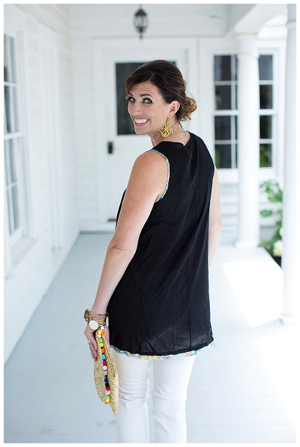 woman looking back and wearing top Black and White pants outfit