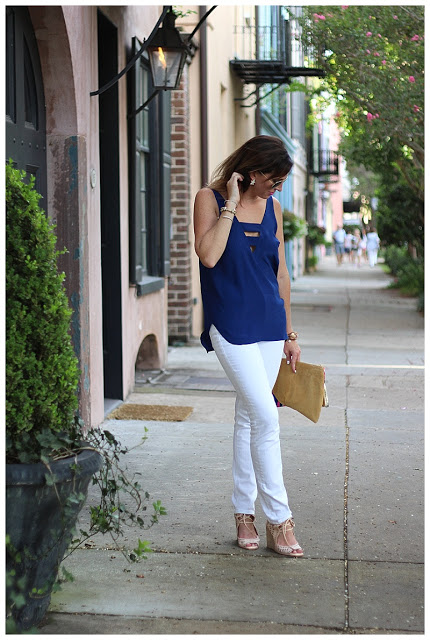 woman in navy & white outfit and standing on the walkway 