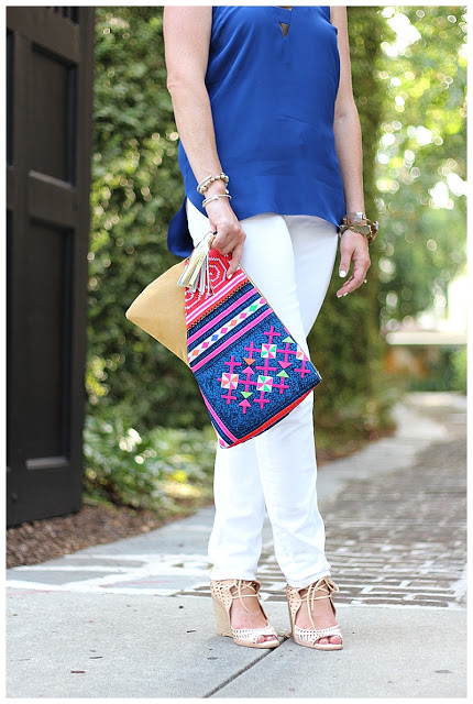 woman in Navy & White outfit with printed pouch  and nude heels 