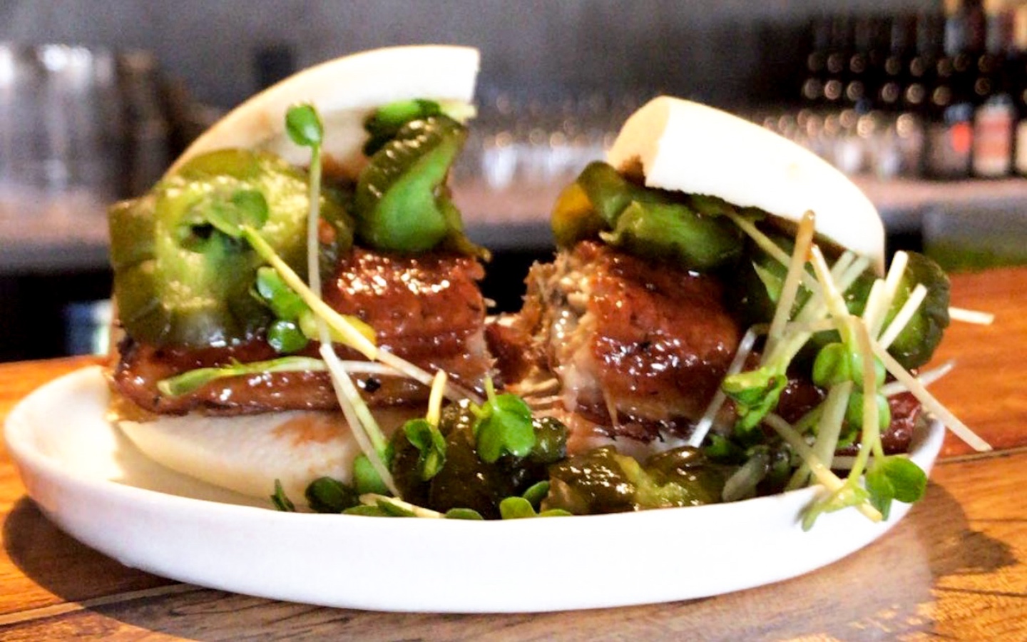 a chicken sandwich on a white plate. a chicken sandwich on a white plate.