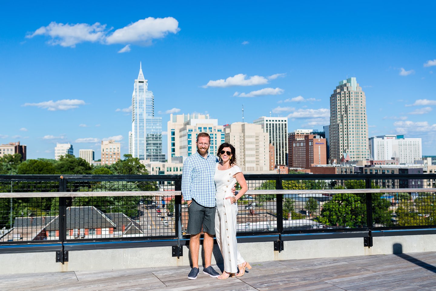 Celebrating 5 Years of Marriage: Lessons Learned - I'm Fixin' To - @mbg0112 | Celebrating 5 Years of Marriage: Lessons Learned - I'm Fixin' To - @mbg0112 | Celebrating 5 Years of Marriage: Lessons Learned by popular North Caroline Life and Style blog, I'm Fixin' To: image of husband and wife standing next to each other outside. Woman is wearing a Gal Meets Glam jumpsuit, Nordstrom Ebba Sandal by ONO, Ray-Ban Original Aviator Polarized Sunglasses, and Hunter Blake Earrings.