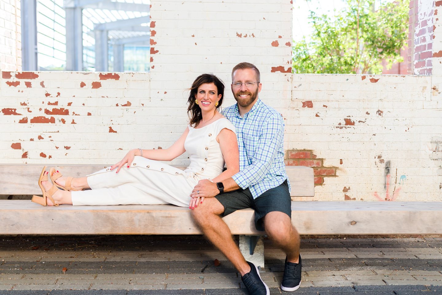 Celebrating 5 Years of Marriage: Lessons Learned - I'm Fixin' To - @mbg0112 | Celebrating 5 Years of Marriage: Lessons Learned by popular North Caroline Life and Style blog, I'm Fixin' To: image of a husband and wife sitting next to each other in an industrial space.