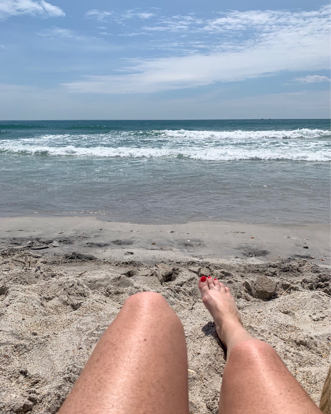 Welcome July + June Instagram Roundup - I'm Fixin' To - @mbg0112 | Welcome July + June Instagram Fashion Roundup by popular North Carolina life and style blog, I'm Fixin' To: image of a woman's feet resting in the sand at the beach.