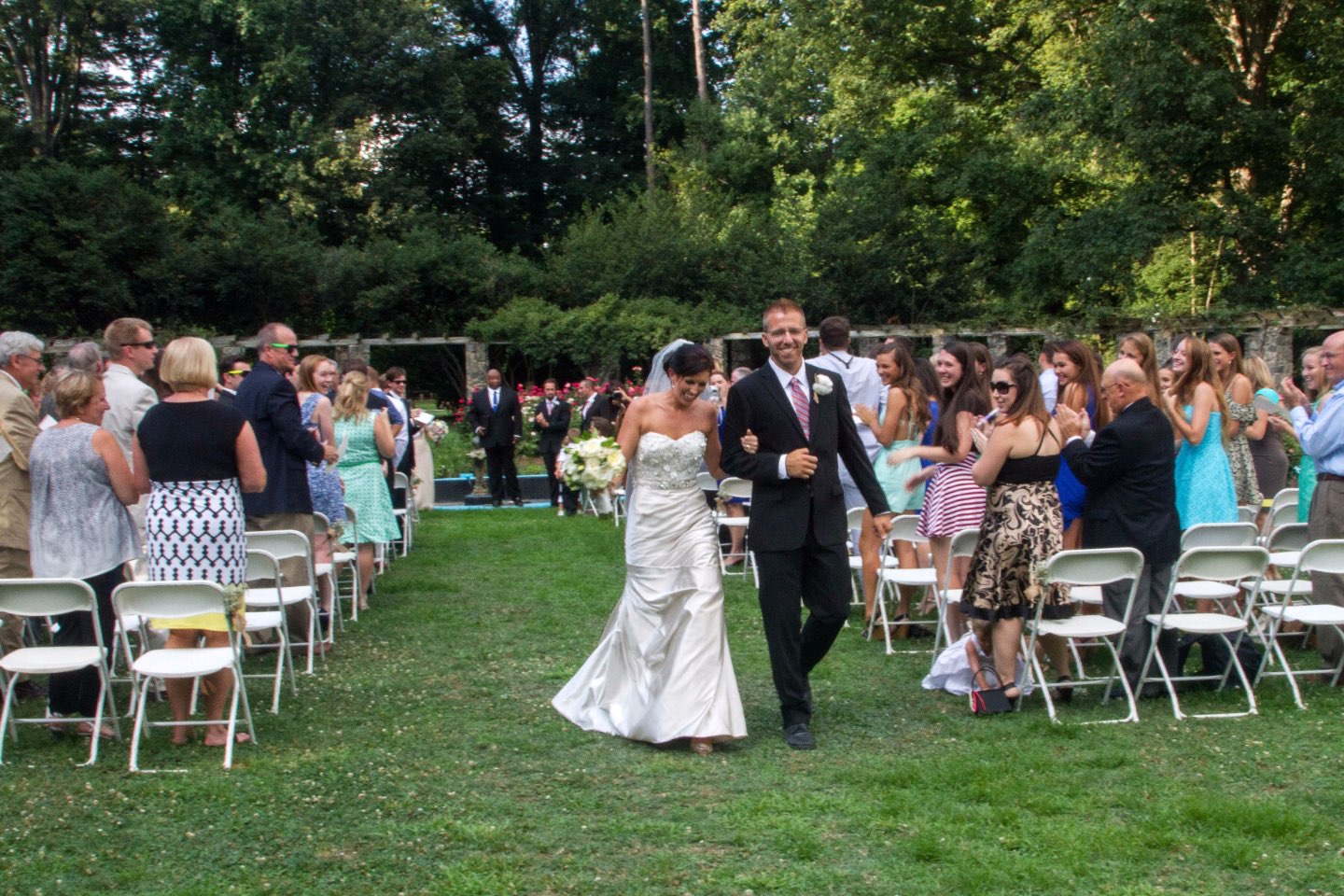 Welcome July + June Instagram Roundup - I'm Fixin' To - @mbg0112 | Welcome July + June Instagram Fashion Roundup by popular North Carolina life and style blog, I'm Fixin' To: image of a woman wearing a wedding dress and a man wearing a suit and walking down the wedding aisle at their outdoor wedding venue. 