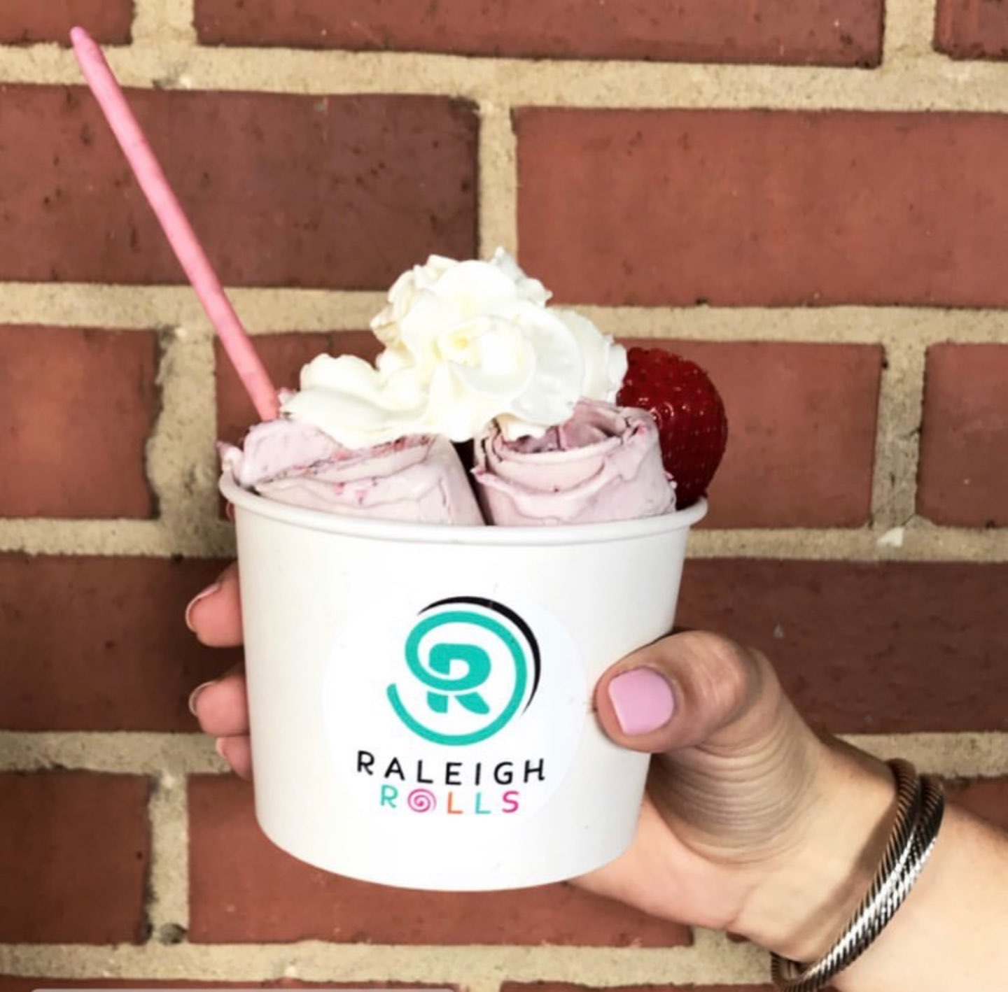 Welcome July + June Instagram Roundup - I'm Fixin' To - @mbg0112 | Welcome July + June Instagram Fashion Roundup by popular North Carolina life and style blog, I'm Fixin' To: image of manicured hand holding a up of Raleigh Rolls ice cream.