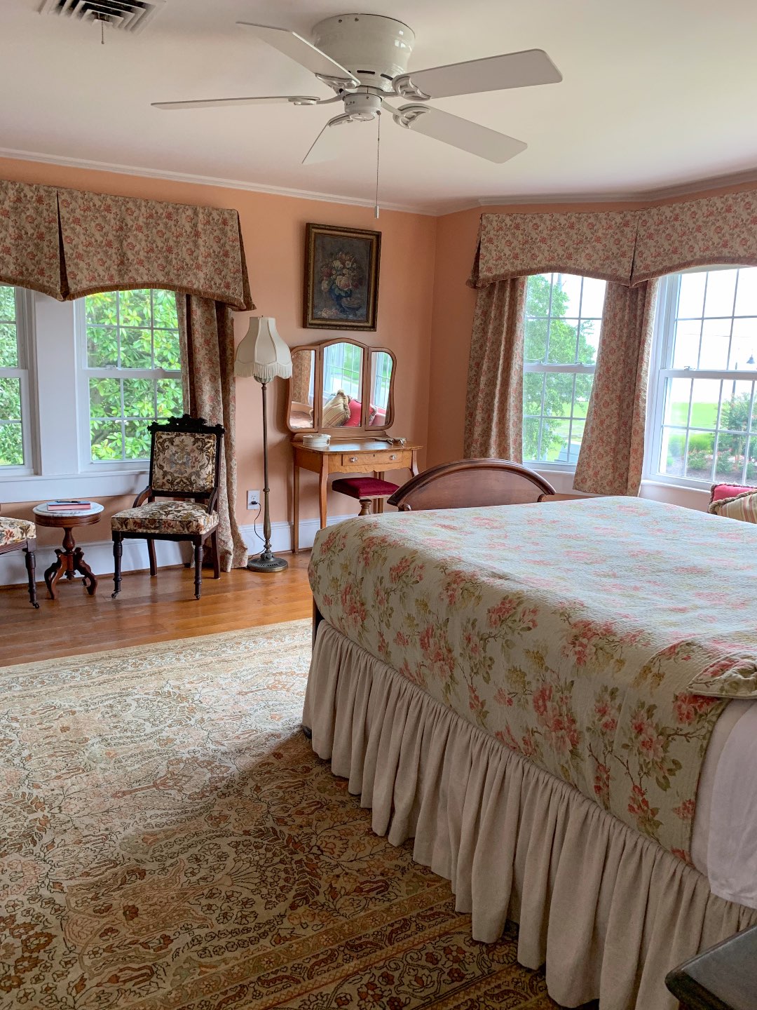 North Carolina Favorite: Between Water and Main Bed & Breakfast in Belhaven - I'm Fixin' To - @mbg0112 | North Carolina Favorite: Between Water and Main Bed & Breakfast in Belhaven by popular North Carolina Blogger, I'm Fixin' To: image of a peach and pink hued bedroom at Between Water and Main Bed and Breakfast.