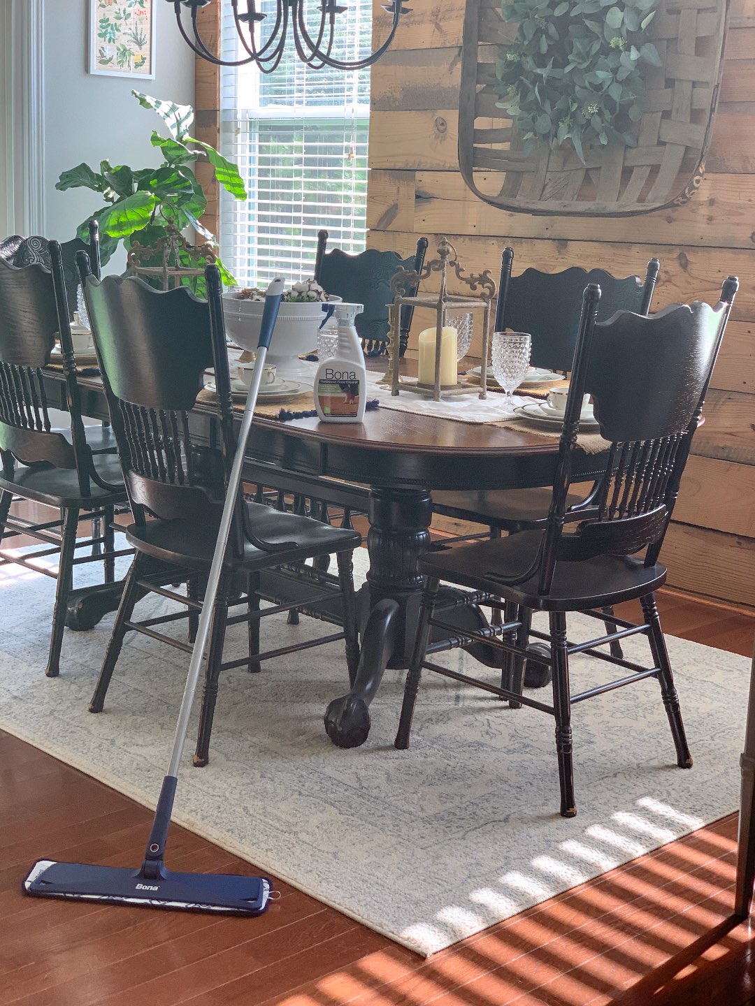 Keeping Our Floors Clean with Bona Essentials - I'm Fixin' To - @mbg0112 | Keeping Our Floors Clean with Bona Essentials by popular lifestyle blog, I'm Fixin' To: image of a bottle of Bona Essentials floor cleaner on a kitchen table and a Bona Essentials mop resting agains the kitchen table.