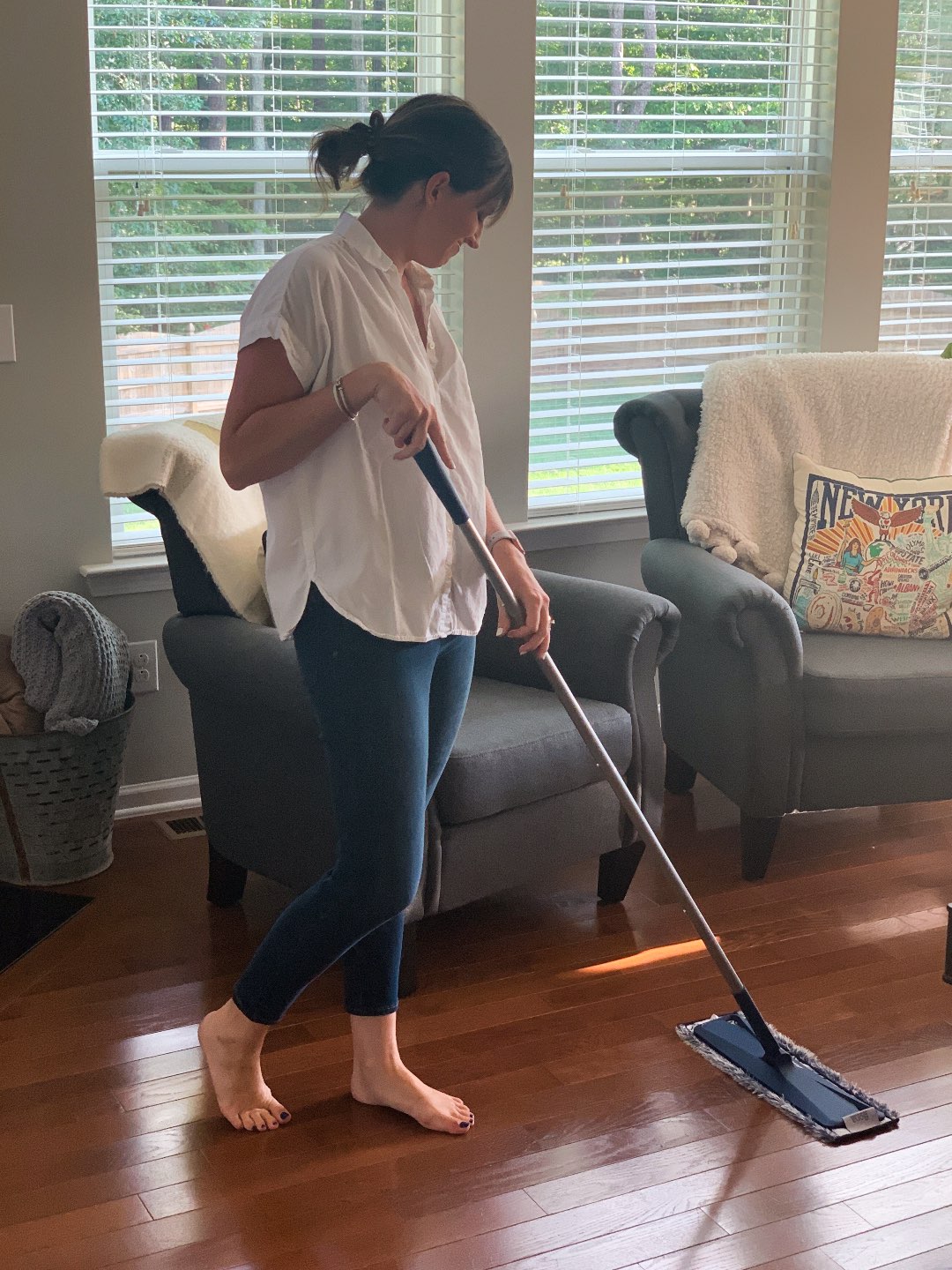 Keeping Our Floors Clean with Bona Essentials - I'm Fixin' To - @mbg0112 | Keeping Our Floors Clean with Bona Essentials by popular lifestyle blog, I'm Fixin' To: image of a woman moping her floor with a Bona Essentials mop.