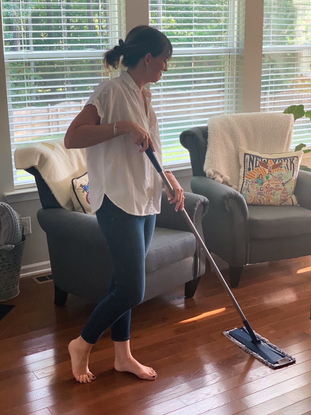 Keeping Our Floors Clean with Bona Essentials - I'm Fixin' To - @mbg0112 | Keeping Our Floors Clean with Bona Essentials by popular lifestyle blog, I'm Fixin' To: image of a woman moping her floor with a Bona Essentials mop.