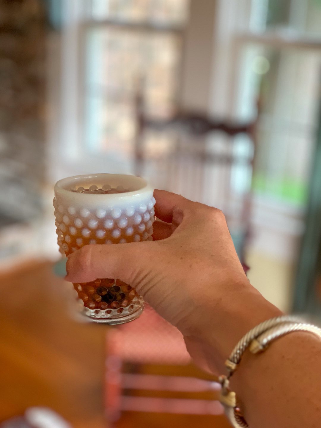 Welcome August + July 2019 Instagram Roundup - I'm Fixin' To - @mbg0112 | Welcome August + July 2019 Instagram Roundup by popular North Carolina life and style blog, I'm Fixin' To: image of woman holding a hobnail milk glass cup at Between Water and Main Bed and Breakfast.