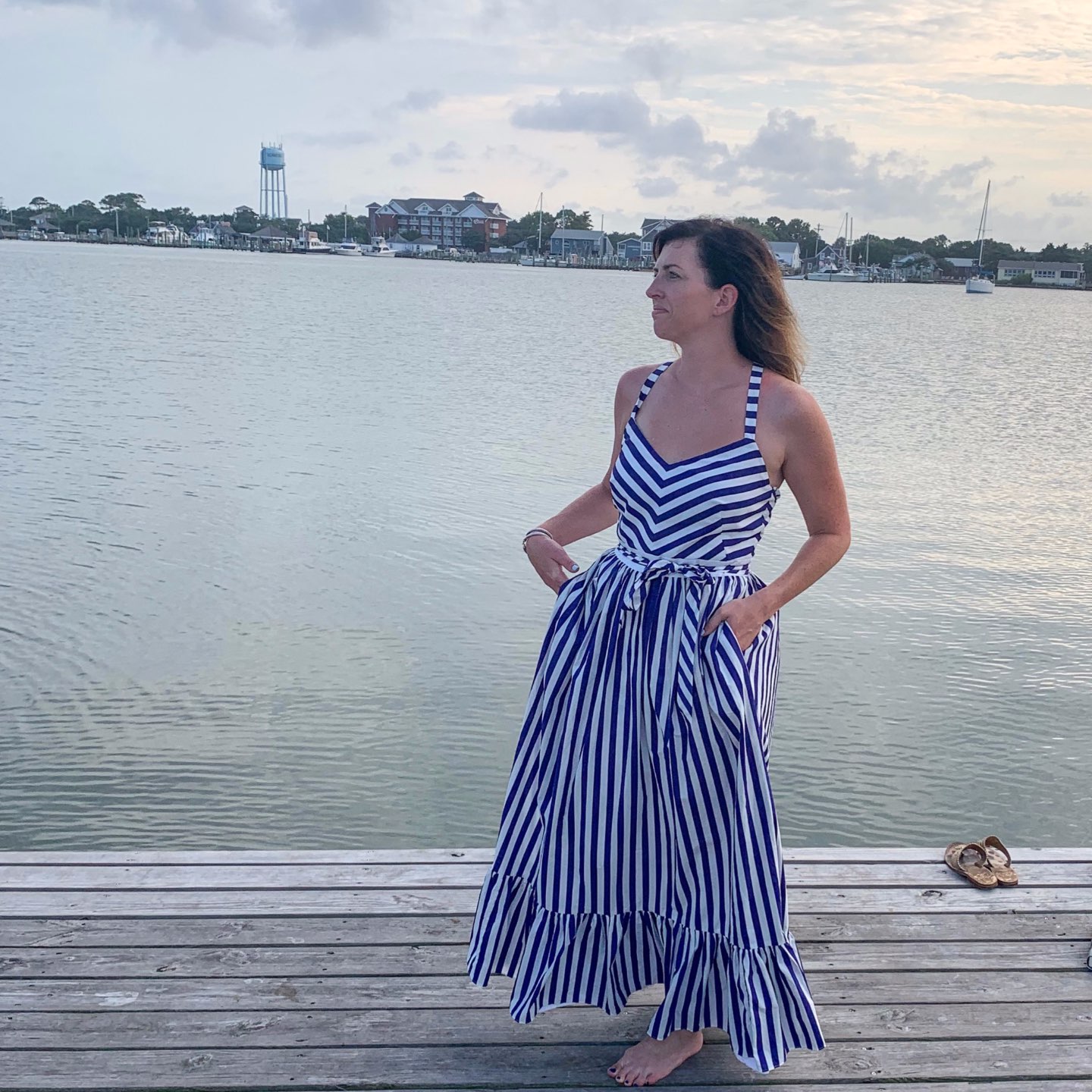 Welcome August + July 2019 Instagram Roundup - I'm Fixin' To - @mbg0112 | Welcome August + July 2019 Instagram Roundup by popular North Carolina life and style blog, I'm Fixin' To: image of woman standing on a dock and wearing a J. Crew Stripe Ruffle Cotton Maxi Dress.