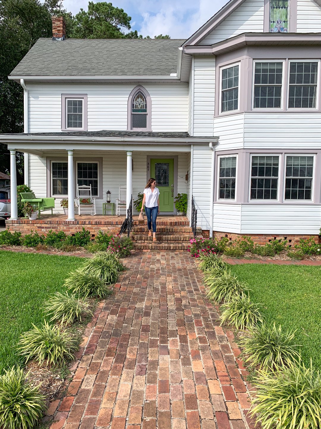 Top 10 Best Things to Do in Belhaven NC, a Complete Travel Guide - I'm Fixin' To - @mbg0112 | Top 10 Best Things to Do in Belhaven NC, a Complete Travel Guide by popular NC blog, I'm Fixiin' To, image of a woman standing on the front steps of Between Water and Main.