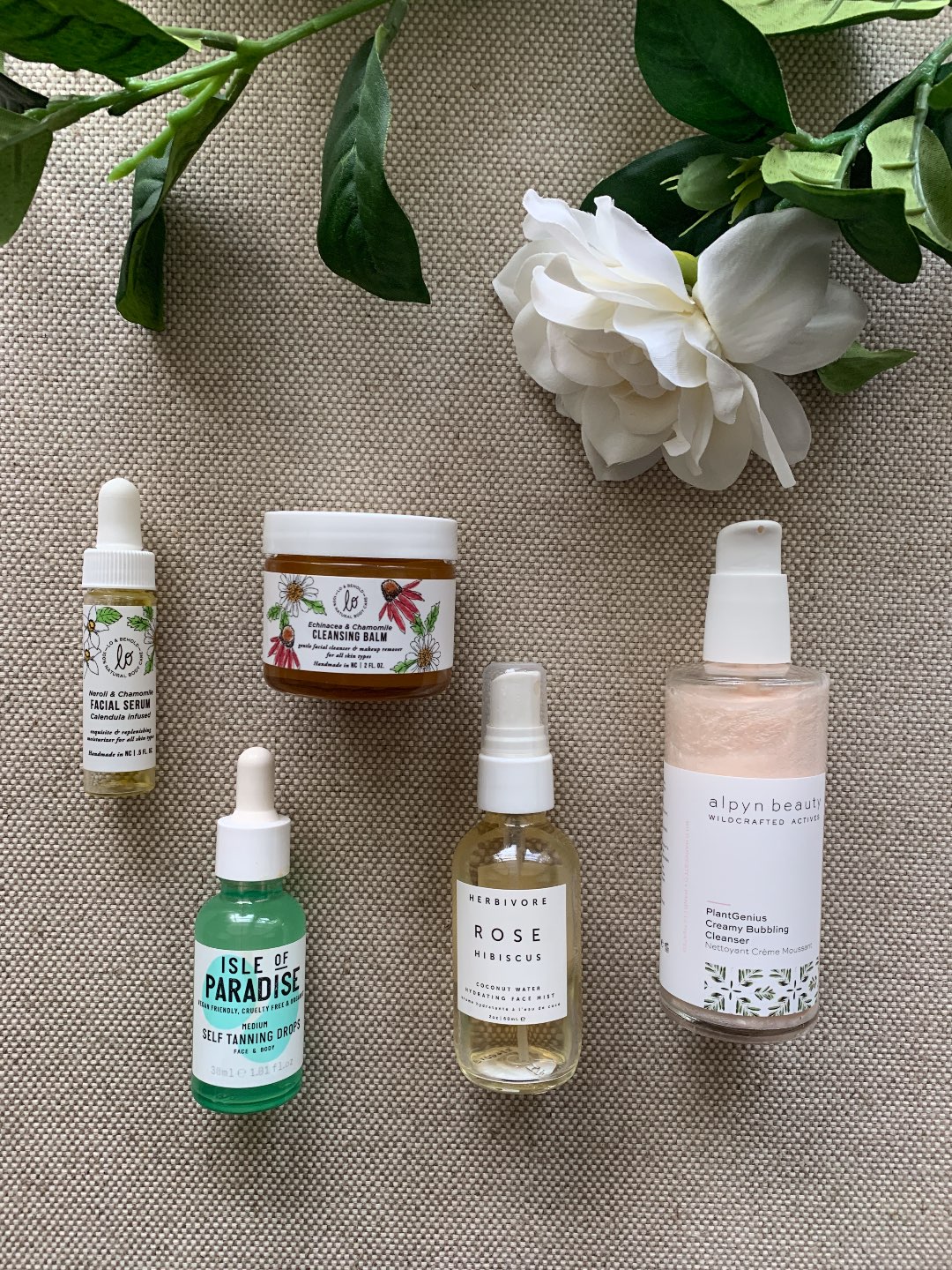 Fall Skincare Routine: Top 10 Products to Use this Season - I'm Fixin' To - @mbg0112 | Fall Skincare Routine: Top 10 Products to Use this Season by popular North Carolina beauty blog, I'm Fixin' To: image of Lo & Behold Cleansing Balm, Alpyn Beauty Wildcrafted Creamy Bubbling Cleanser, Herbivore Rose Water Spray, Lo & Behold Neroli & Chamomile Facial Serum, and Isle of Paradise Self Tanning Drops. 