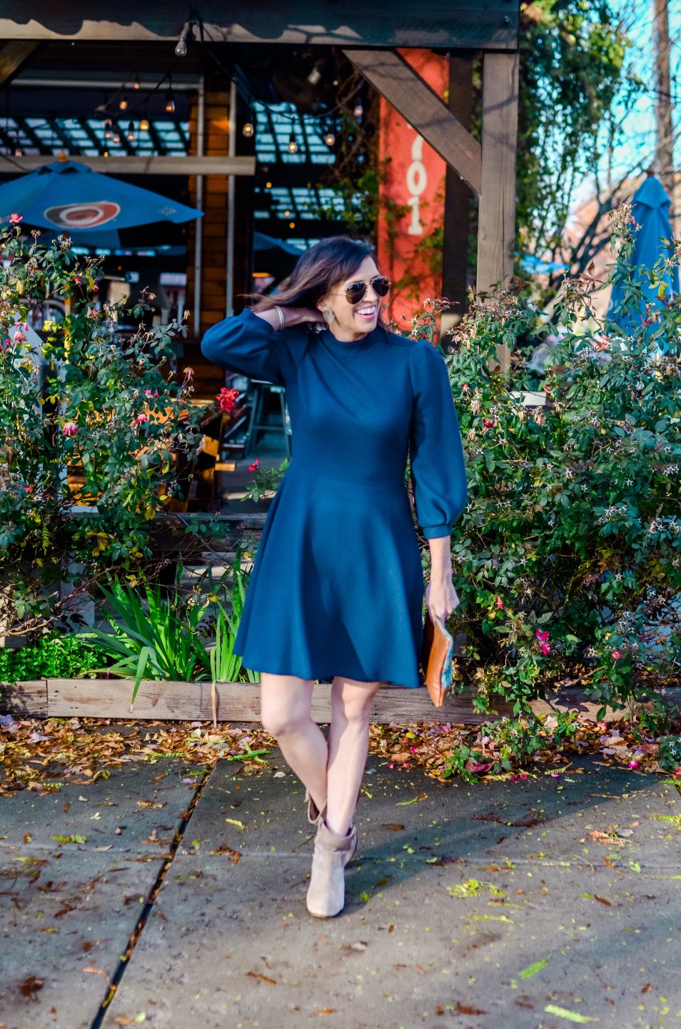 Holiday Style and Outfit Inspiration - I'm Fixin' To - @mbg0112 | Holiday Style and Outfit Inspiration by popular North Carolina fashion blog, I'm Fixin' To: image of a woman outside wearing a Gal Meets Glam Maggie Dress, Nordstrom 'Aviator' Polarized 62mm Sunglasses, Vince Camuto ankle boots, Etsy Up a Tree Cup a Tea Pine Cone Bloom Overshot Textile and Leather Clutch, Nordstrom David Yurman Cable Classic Buckle Bracelet with 18K Gold, Nordstrom David Yurman Cable Classics Bracelet with 14K Gold, Nordstrom Mignonne Gavigan Earrings, and Sephora Bite Beauty lipstick.