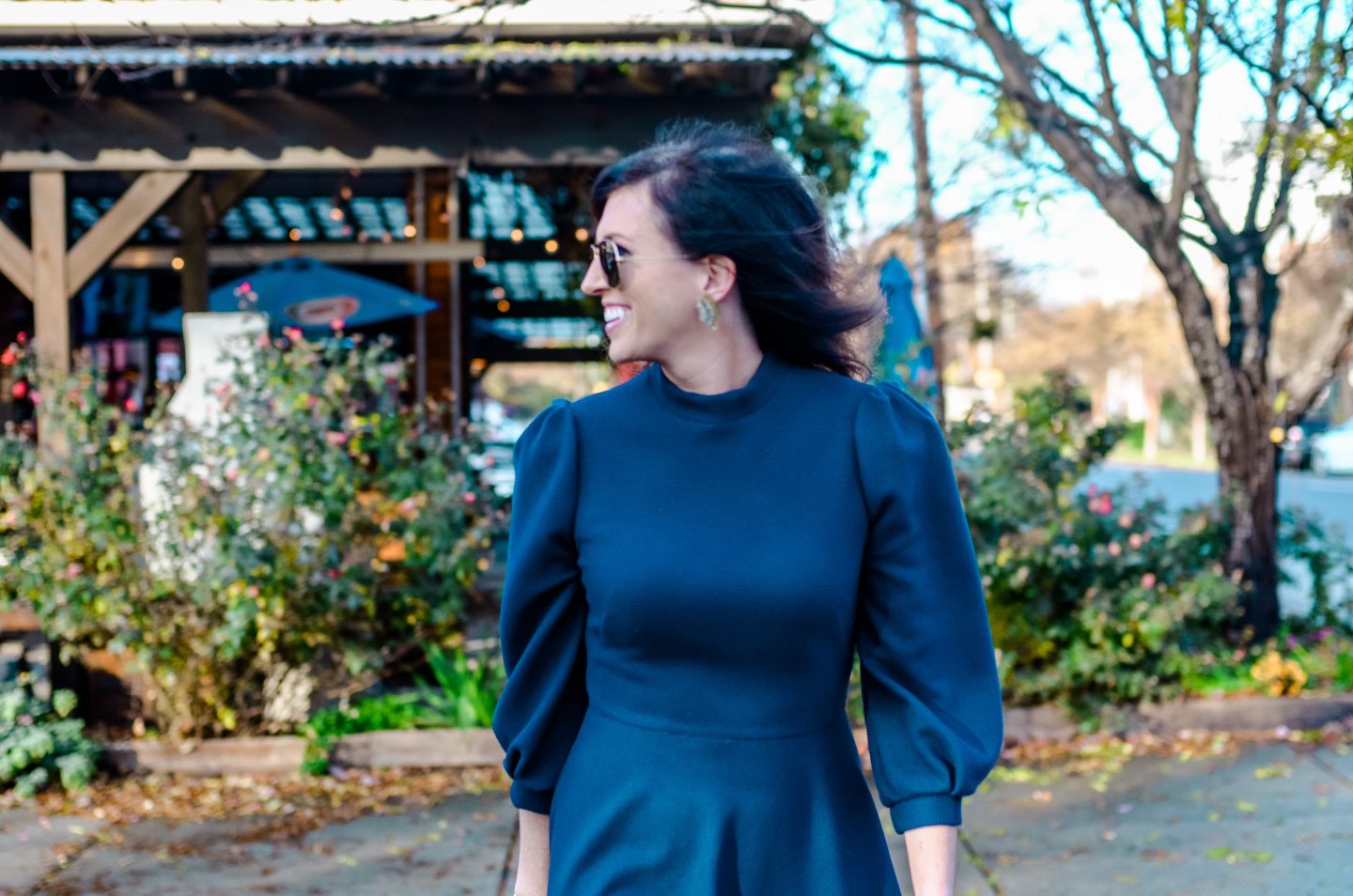 Holiday Style and Outfit Inspiration - I'm Fixin' To - @mbg0112 | Holiday Style and Outfit Inspiration by popular North Carolina fashion blog, I'm Fixin' To: image of a woman outside wearing a Gal Meets Glam Maggie Dress, Nordstrom 'Aviator' Polarized 62mm Sunglasses, Vince Camuto ankle boots, Etsy Up a Tree Cup a Tea Pine Cone Bloom Overshot Textile and Leather Clutch, Nordstrom David Yurman Cable Classic Buckle Bracelet with 18K Gold, Nordstrom David Yurman Cable Classics Bracelet with 14K Gold, Nordstrom Mignonne Gavigan Earrings, and Sephora Bite Beauty lipstick.