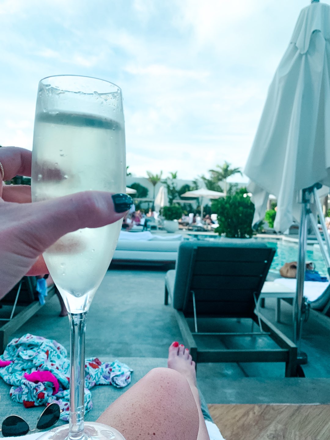 Warming Up in the Bahamas: the Best Things to Do at Baha Mar - I'm Fixin' To - @mbg0112 | Warming Up in the Bahamas: the Best Things to Do in Baha Mar by popular North Carolina travel blog, I'm Fixin' To: image of woman sitting by a pool at the Baha Mar. 