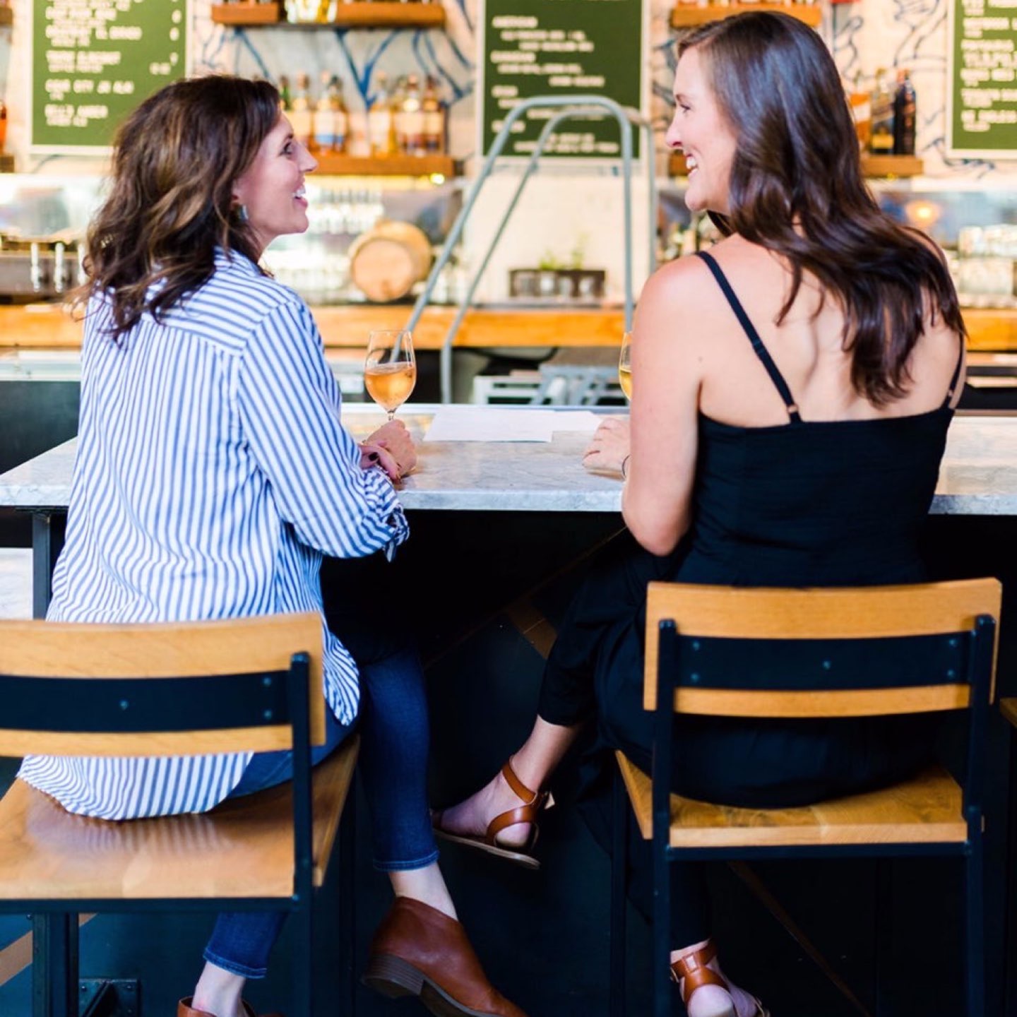 How to Set Healthy Boundaries with Friends: 8 Essential Tips - I'm Fixin' To - @mbg0112 | How to Set Healthy Boundaries with Friends: 8 Essential Tips by popular NC life and style blog, I'm Fixin' To: image of a woman sitting at a bar with a friend.