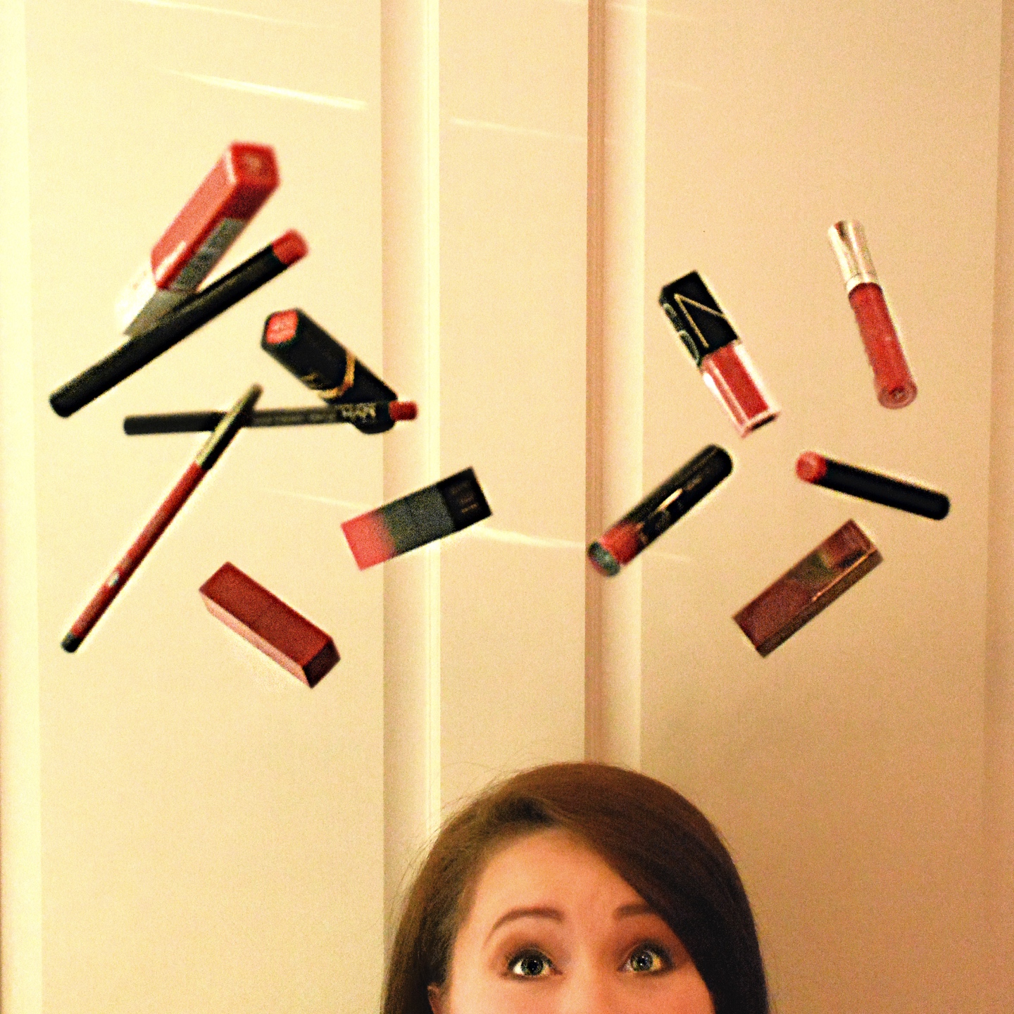 The Empowered Women Series: How to Rock a Red Lip with Hannah Dawson - I'm Fixin' To - @mbg0112 | Hannah Hardy by popular NC beauty blog, I'm Fixin' To: image of Hannah Hardy throwing red lipstick, red lipliner, and red lipgloss in the air. 