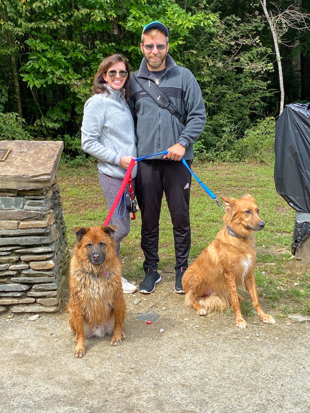 A Casual Weekend in Asheville: the Best Things to Do with your Dogs - I'm Fixin' To - @mbg0112 | Weekend In Asheville by popular NC travel blog, I'm Fixin' To: image of a man and woman standing together outside with their dogs. 