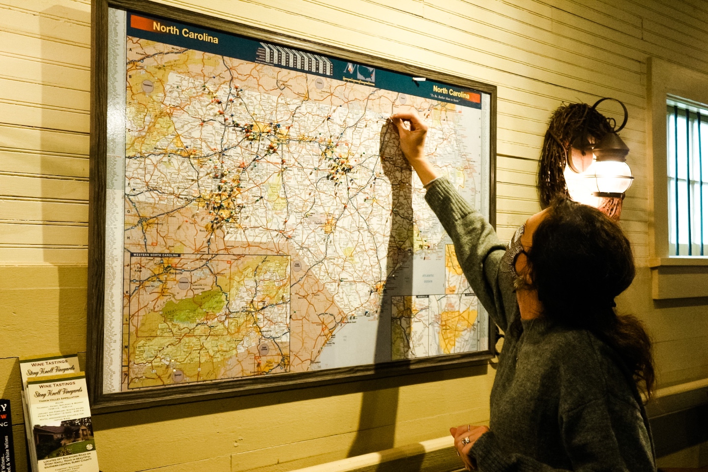 Western NC Wineries: 6 Wineries to Visit During your Next Girls' Weekend - I'm Fixin' To - @mbg0112 |Western NC Wineries by popular NC blog, I'm Fixin' To: image of a woman putting a pin in a North Carolina map. 
