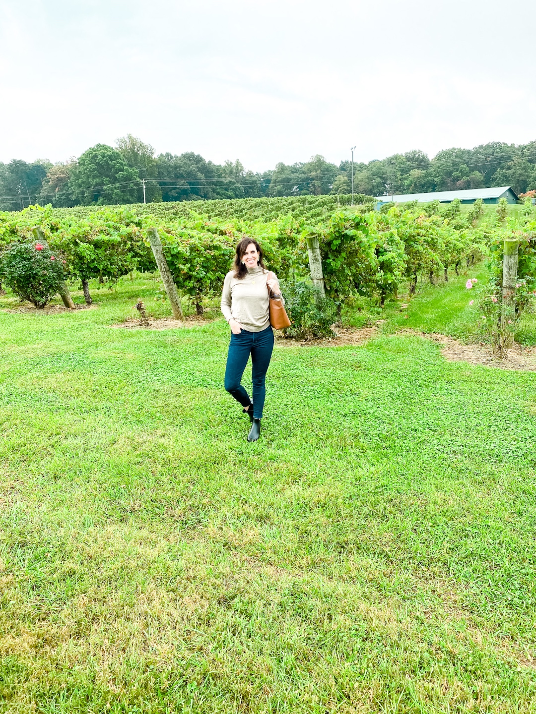 Western NC Wineries: 6 Wineries to Visit During your Next Girls' Weekend - I'm Fixin' To - @mbg0112 |Western NC Wineries by popular NC blog, I'm Fixin' To: image of a woman standing outside at Shelton Vineyards. 