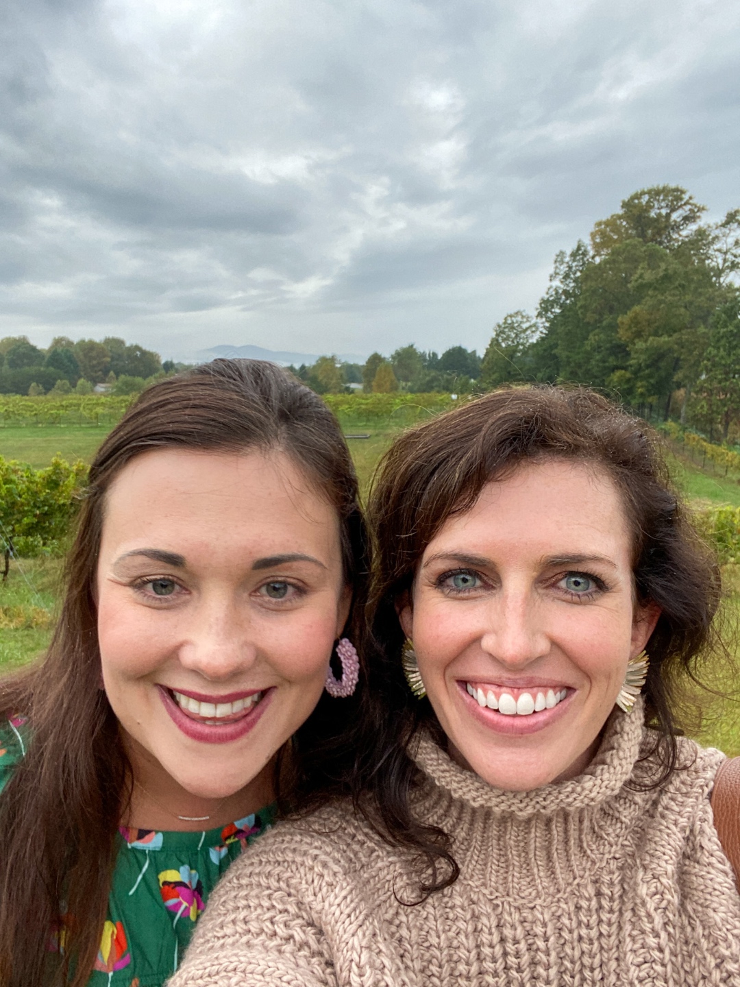 Western NC Wineries: 6 Wineries to Visit During your Next Girls' Weekend - I'm Fixin' To - @mbg0112 |Western NC Wineries by popular NC blog, I'm Fixin' To: image of two women standing outside at Round Peak Vineyards. 