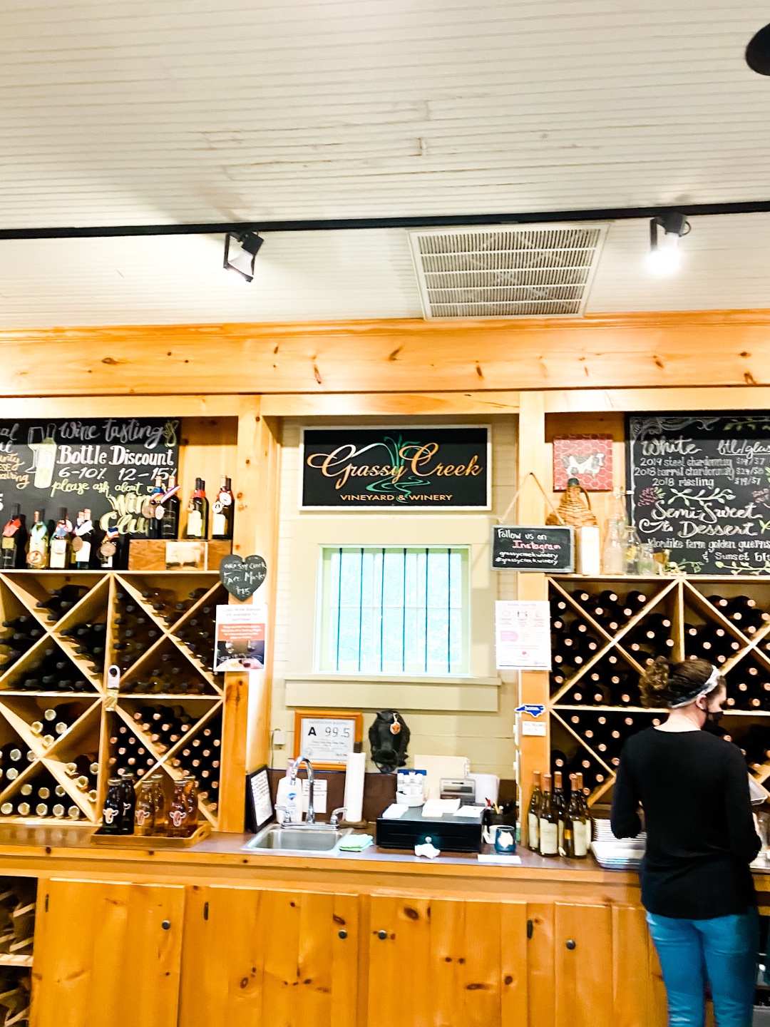 Western NC Wineries: 6 Wineries to Visit During your Next Girls' Weekend - I'm Fixin' To - @mbg0112 |Western NC Wineries by popular NC blog, I'm Fixin' To: image of wine displays at Grassy Creek vineyard and winery. 
