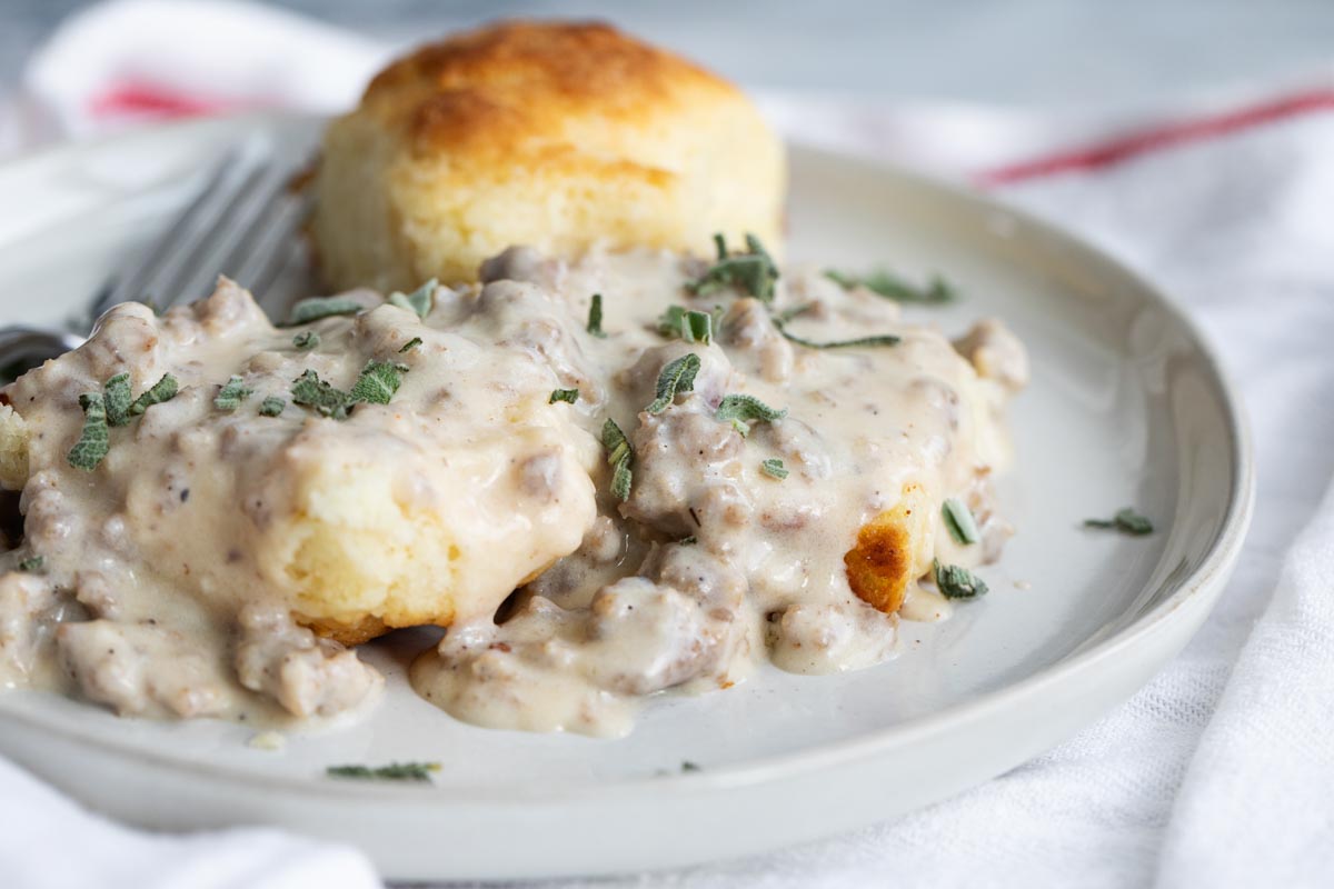 Best Southern Food by popular N.C. lifestyle blog, I'm Fixin' To: image of a plate of biscuits and gravy. 