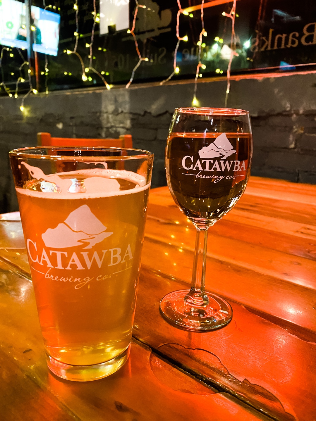 Christmas in Asheville: a Weekend Getaway During the Holidays - I'm Fixin' To - @imfixintoblog |Christmas in Asheville NC by popular NC lifestyle blog, I'm Fixin' To: image of a glass of beer and a glass of wine at Catabaw Brewing Company. 