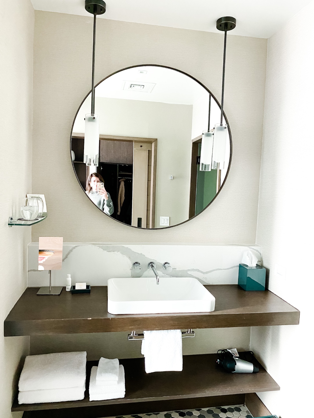 Christmas in Asheville: a Weekend Getaway During the Holidays - I'm Fixin' To - @imfixintoblog |Christmas in Asheville NC by popular NC lifestyle blog, I'm Fixin' To: image of a bathroom vanity with a round black mirror. 