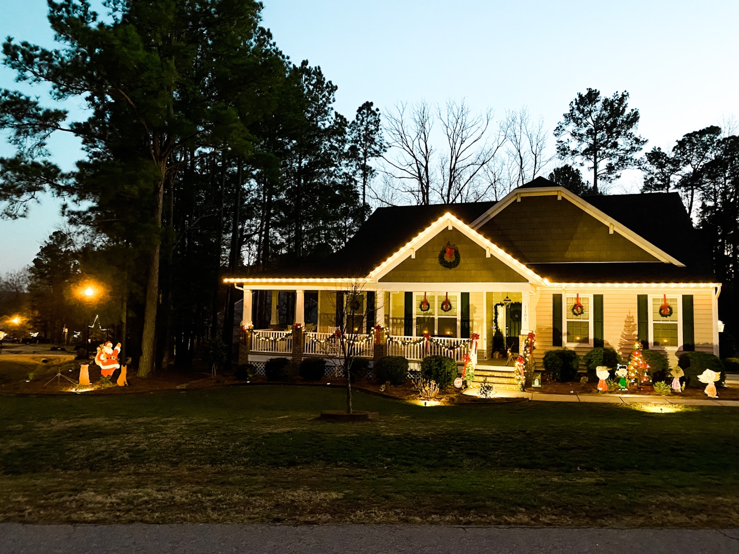 2020 Holiday Home Tour - I'm Fixin' To - @mbg0112 | Holiday Home Tour by popular NC life and style blog, I'm Fixin' To: image of a home decorated with Christmas wreaths, garland, white lights, red ribbons, and Charlie Brown Christmas decor. 