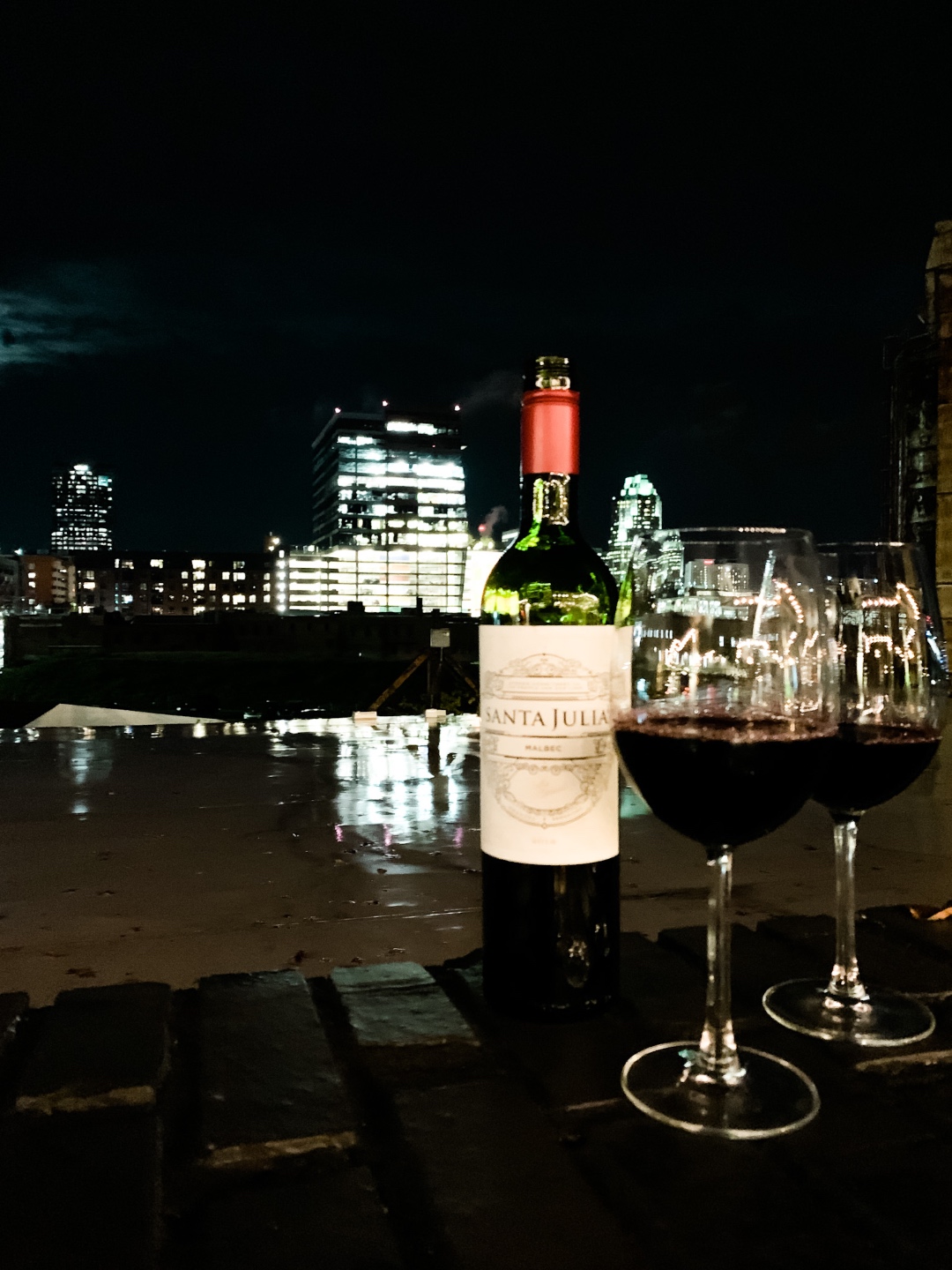 NC Favorites: 5 Warm Restaurants with Patios in the Triangle - I'm Fixin' To - @mbg0112 |Restaurants with Patios in the Triangle by popular NC lifestyle blog, I'm Fixin' To: image of a bottle of red wine next to two wine glasses filled with red wine.