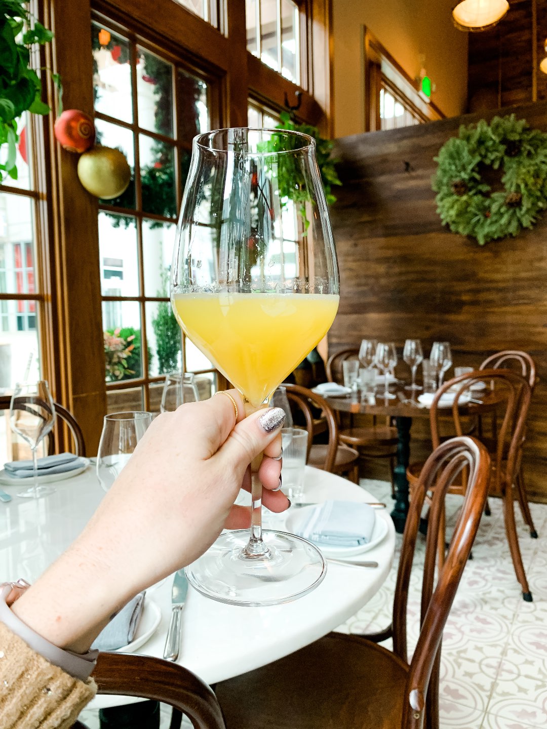 Most Popular Posts of 2020 - I'm Fixin' To - @imfixintoblog |Most Popular Posts by popular NC lifestyle blog, I'm Fixin' To: image of a woman sitting in a restaurant and holding a glass of wine. 