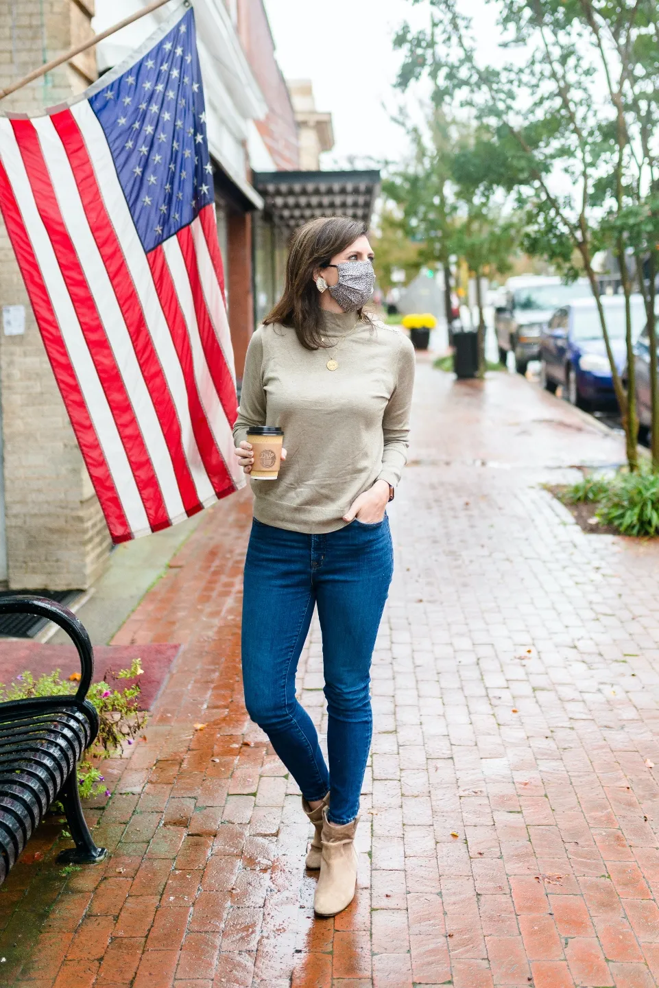 2020, a Year in Review: our Travel Adventures - I'm Fixin' To - @imfixintoblog |Year in Review by popular NC travel blog, I'm Fixin' To: image of a woman holding a cup of coffee and standing next to an American flag.