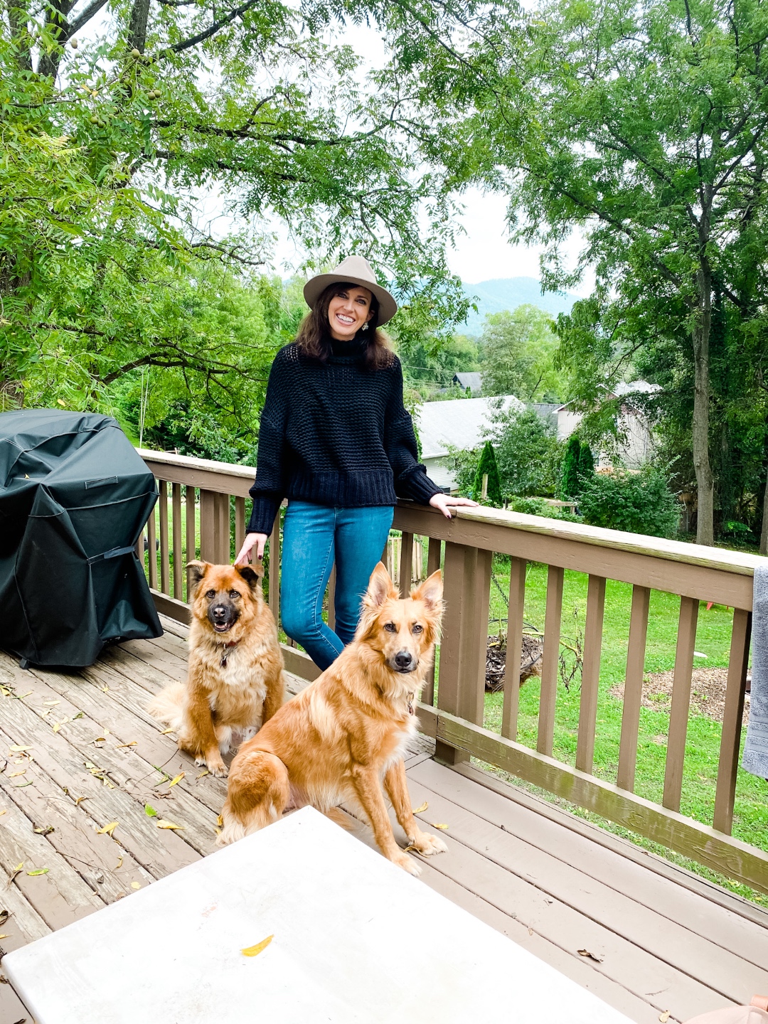 2020, a Year in Review: our Travel Adventures - I'm Fixin' To - @imfixintoblog |Year in Review by popular NC travel blog, I'm Fixin' To: image of a woman standing on a wooden deck with her two dogs.