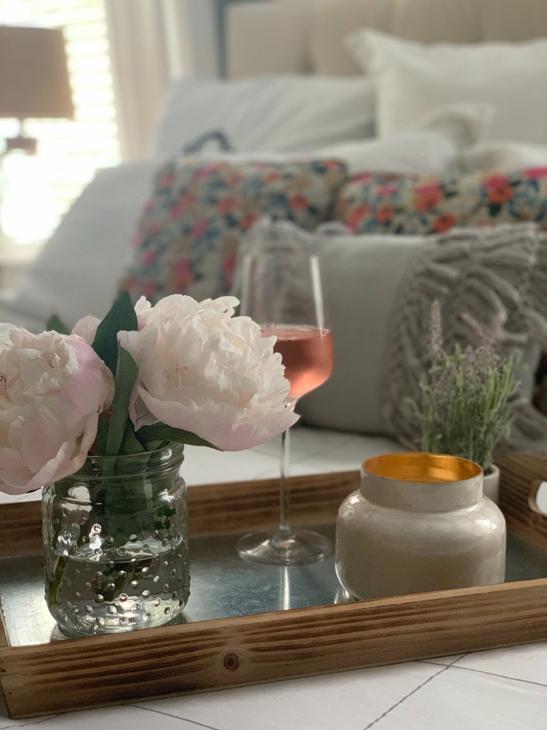 How to Make your Home Cozy: 10 Easy Ways - I'm Fixin' To - @imfixintoblog |How to Make Your Home Cozy by popular NC life and style blog, I'm Fixin' To: image of a serving tray set with a vase of flowers, candle, and glass of wine. 
