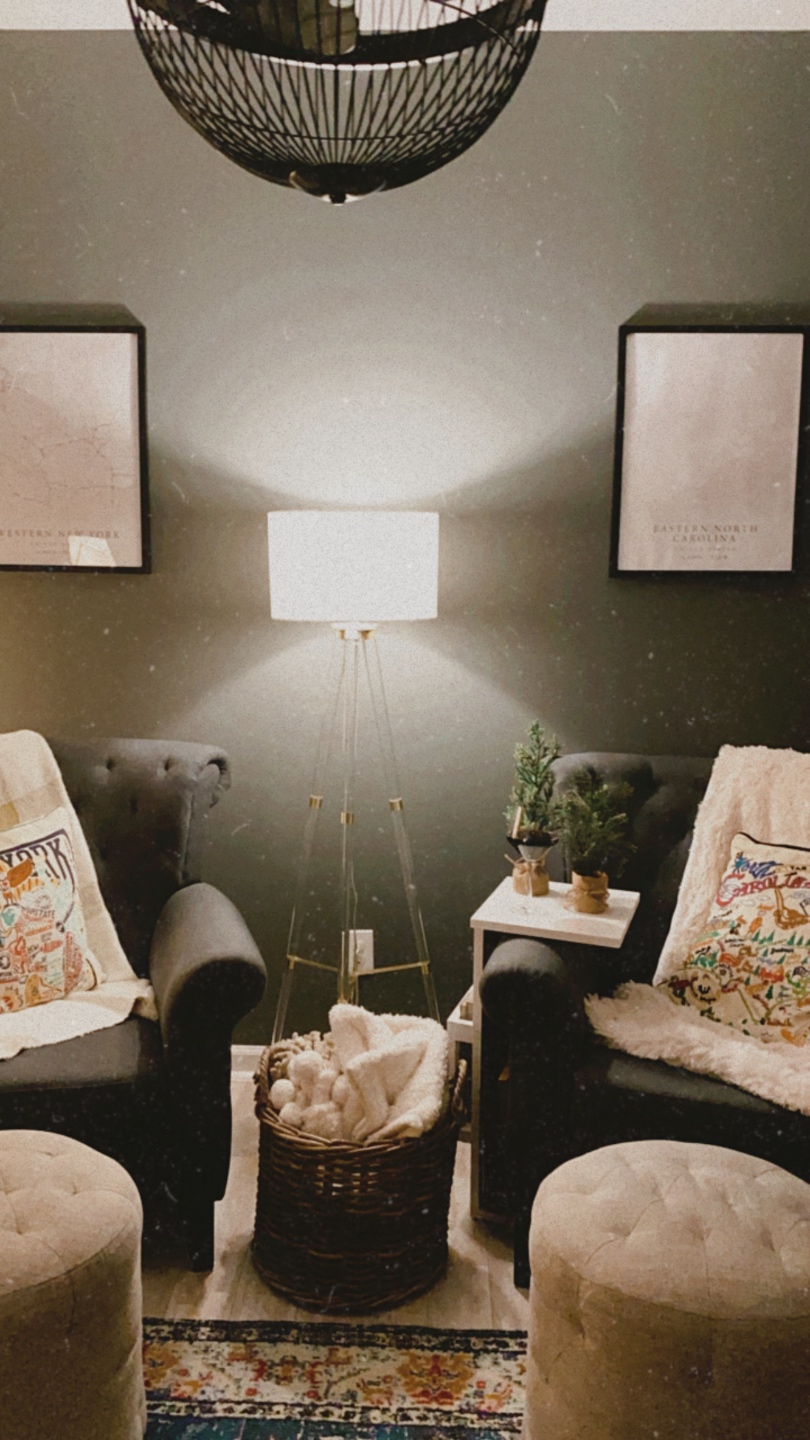 How to Make your Home Cozy: 10 Easy Ways - I'm Fixin' To - @imfixintoblog |How to Make Your Home Cozy by popular NC life and style blog, I'm Fixin' To: image of a sitting area with grey tuft armchairs, tan tuft ottomans, floor lamp, and embroidered throw pillows. 