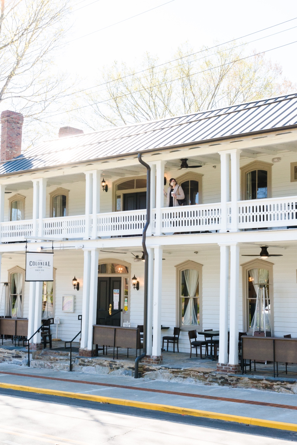 Places to Stay: The Colonial Inn in Hillsborough NC - I'm Fixin' To - @imfixintoblog |The Colonial Inn Hillsborough NC by popular NC travel blog, I'm Fixin' To: image of a woman standing outside at the The Colonia Inn in Hillsborough NC.