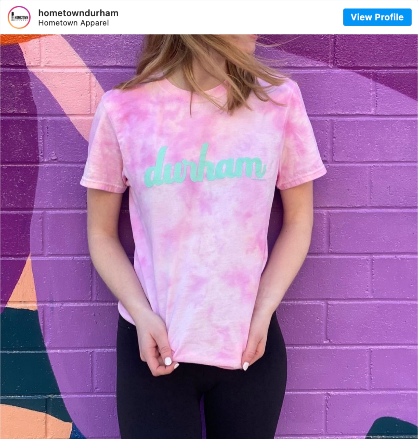 Durham Shopping: Top 11 Best Fashion Boutiques to visit After a Year of Quarantine - I'm Fixin' To - @imfixintoblog | Durham Shopping by popular NC lifestyle blog, I'm Fixin' To: image of a woman wearing a tie dye durham t-shirt. 