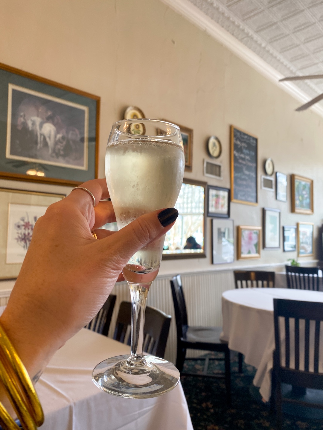 Side Street Restaurant woman holding a glass of champaign in Side Street Restaurant