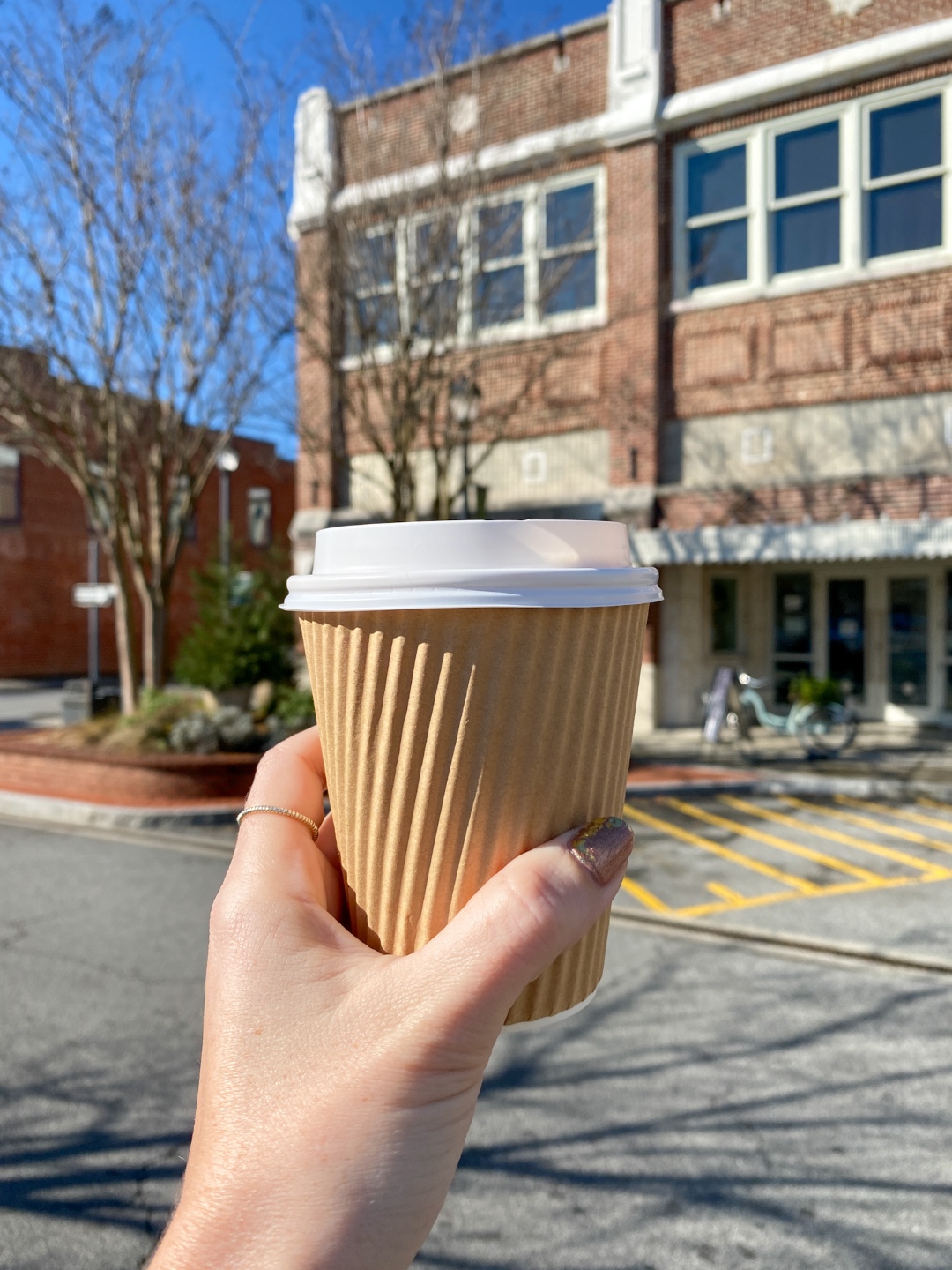 An Update on My North Carolina 100 County Tour - I'm Fixin' To - @imfixintoblog | Things to do in North Carolina by popular NC travel blog, I'm Fixin' To: image of a woman holding a cup of coffee. 