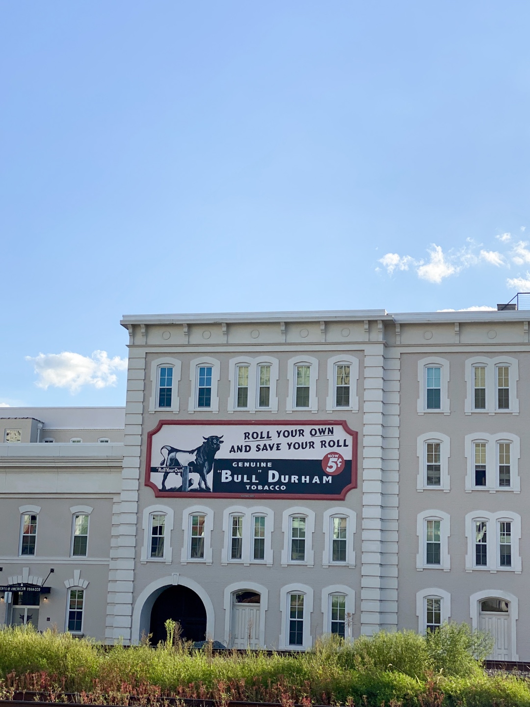 An Update on My North Carolina 100 County Tour - I'm Fixin' To - @imfixintoblog | Things to do in North Carolina by popular NC travel blog, I'm Fixin' To: image of a white building in Bull City. 