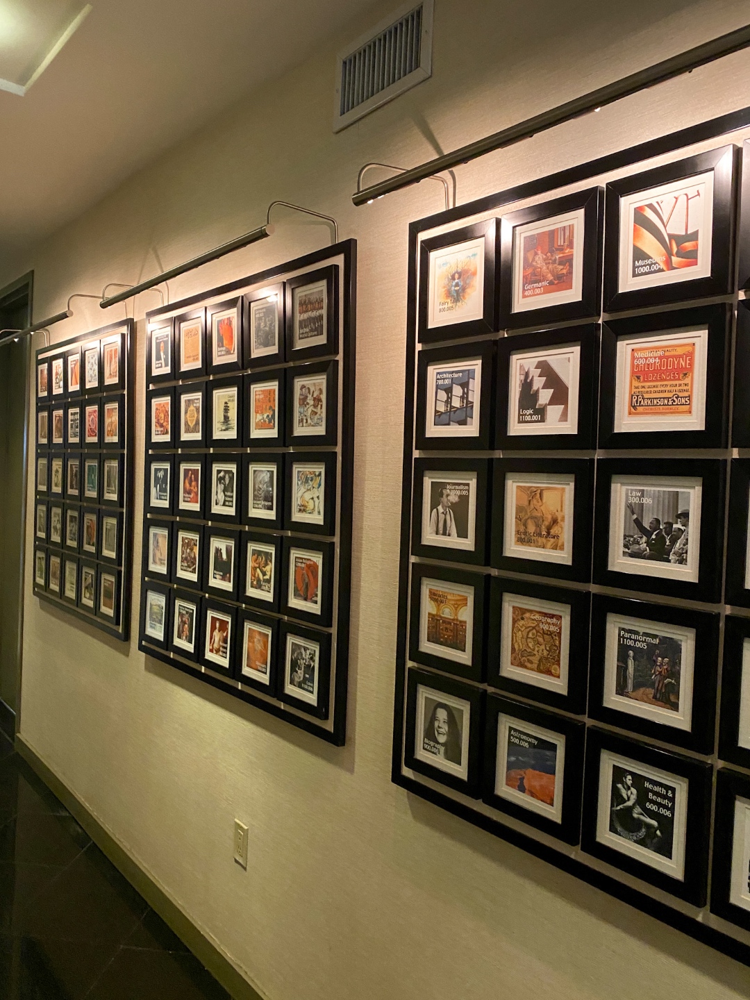 wall of frames in a hallway
