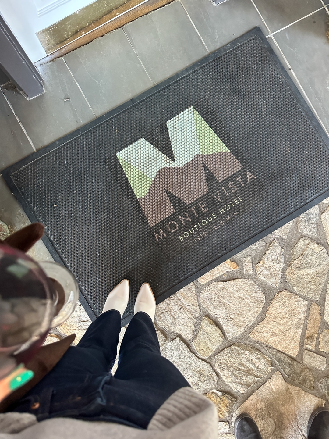 top view of shoes and Monte Vista boutique hotel doormat