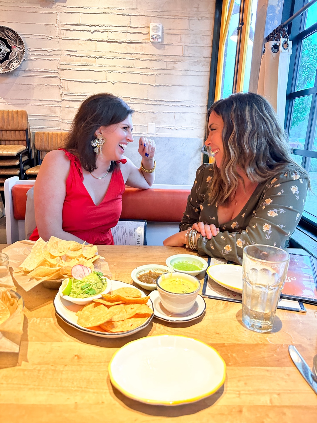 Meghan Grant and a friend laughing during a girls' night in Fenton
